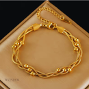 Pulseira Bruna, de aço inoxidável, dourada, corrente enrolada.