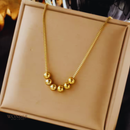 Colar Paty, aço inoxidável, dourado, pingente de bolas.