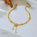 Tornozeleira Pilar, aço inoxidável, dourado, branco strass flor borla dupla.