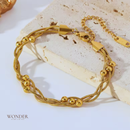 Pulseira Bruna, de aço inoxidável, dourada, corrente enrolada.